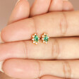 Model holding Green Crystal Stud Earrings in Gold in between fingers