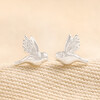 Delicate Bird Stud Earrings in Silver on Beige Fabric