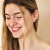 Model Smiling Wearing Irregular Crystal and Pearl Huggie Hoop Earrings in Gold