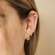 Curated look of Irregular Crystal and Pearl Huggie Hoop Earrings in Gold on model