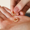 Irregular Crystal and Pearl Huggie Hoop Earrings in Gold in palm of model's hand
