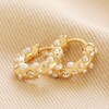 Irregular Crystal and Pearl Huggie Hoop Earrings in Gold on neutral coloured fabric