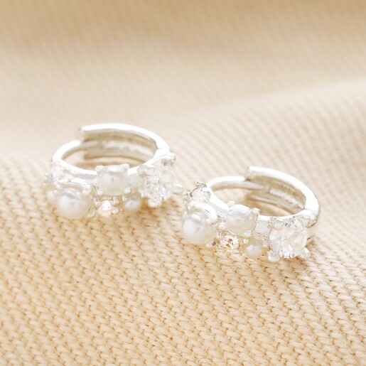 Irregular Pearl and Crystal Huggie Hoop Earrings in Silver on beige fabric