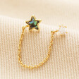 Shell and Crystal Star Chain Stud Earring in Gold on top of neutral coloured fabric