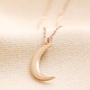 Crescent Moon Pendant Necklace Rose Gold on Beige Fabric