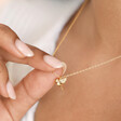 Close up of model wearing the Delicate Bird Pendant Necklace in Gold