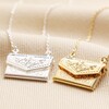 Envelope Locket Necklace in Gold next to silver version on beige coloured fabric