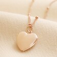 Heart Locket Necklace in Rose Gold on Beige Fabric