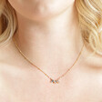 Close Up of Shell Moon and Star Pendant Necklace in Gold on Model