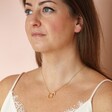 Organic Interlocking Hoops Necklace in Gold on model against neutral coloured backdrop