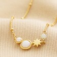 Pearl and Crystal Moon and Stars Necklace in Gold on neutral coloured background