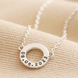 Close up of Personalised Eternity Ring Pendant Necklace in silver against neutral coloured fabric