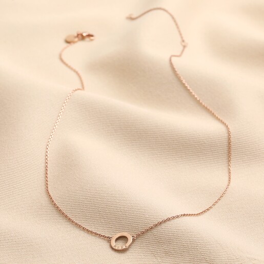 Personalised Eternity Ring Pendant Necklace in rose gold full length on cream coloured fabric