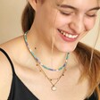 Model smiling wearing curated look with Personalised Talisman Satellite Chain Pendant Necklace in Gold