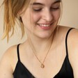Model wearing Personalised Talisman Satellite Chain Pendant Necklace in Gold smiling looking down