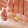 Model holding Personalised Talisman Satellite Chain Pendant Necklace in Gold showing front of pendant in hand