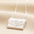 Envelope Locket Necklace in Silver on top of beige coloured fabric