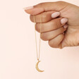 Model Holding Crescent Moon Pendant Necklace in Gold