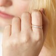 Adjustable Clear Baguette Crystal Band Ring in Gold on model with hand on face