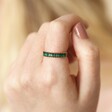 Close up of Adjustable Green Baguette Crystal Band Ring in Gold on model