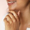 Model Wearing Dainty Pearl and Crystal Stacking Ring in Gold With Hand Under Chin