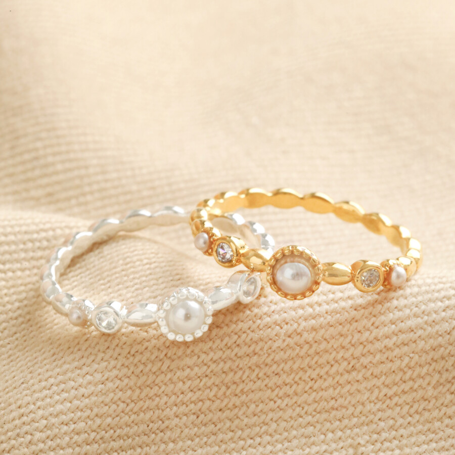 Dainty Pearl and Crystal Ring in Silver on top of beige material