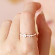Close up of Dainty Pearl and Crystal Stacking Ring in Silver on model