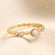 Dainty Rose Quartz and Crystal Ring in Gold on top of beige coloured fabric