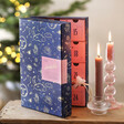 Personalised Fill Your Own Celestial Advent Calendar on top of counter with lit candles next to it