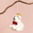 Afroart Felt Christmas Dog Hanging Decoration Hanging on Branch Against Pink Background