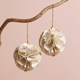 Afroart Set of 2 White and Gold Flower Ball Hanging Decorations hanging from tree branch against neutral coloured background