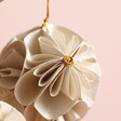 Close up of Afroart Set of 2 White and Gold Flower Ball Hanging Decorations against natural coloured backdrop