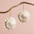 Afroart Set of 2 White and Gold Layered Pinwheel Hanging Decorations hanging from tree branch against neutral coloured background