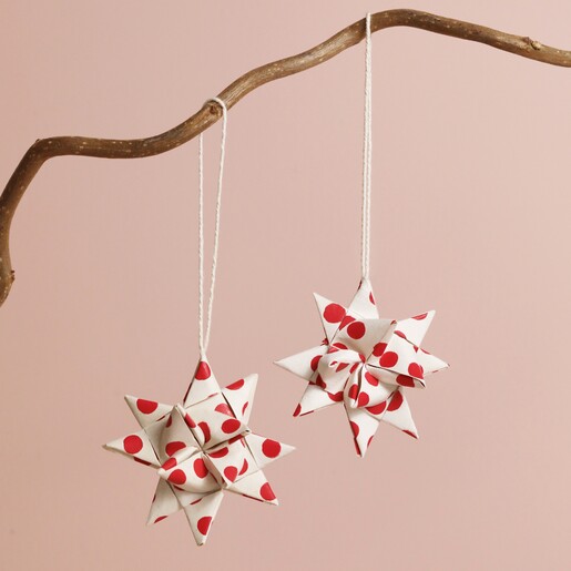 Afroart Set of 2 White and Red Polka Dot Folded Star Hanging Decorations hanging from tree branch against neutral background