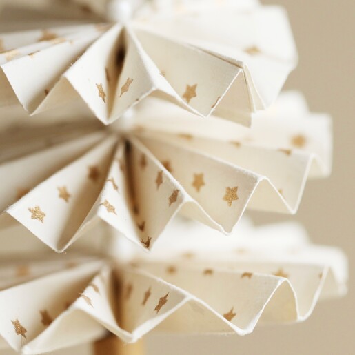 Close up of Afroart White and Gold Christmas Tree Hanging Decoration against natural coloured background