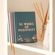 Teal Floral 52 Weeks of Positivity Diary in lifestyle shot with reed diffuser next to it on shelf