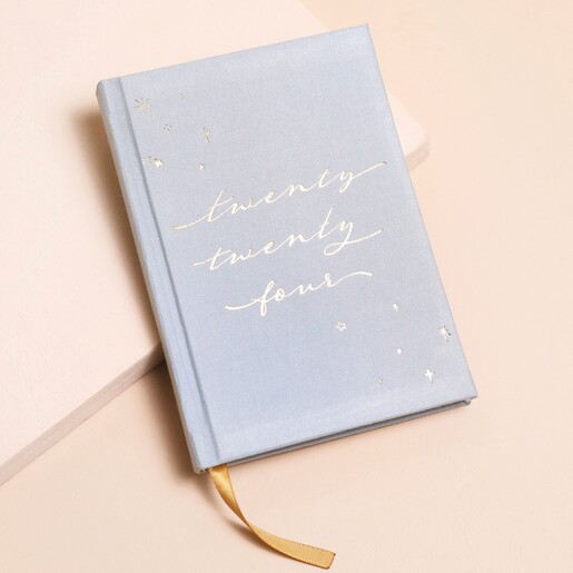Dusky Blue 2024 Diary on top of beige surface