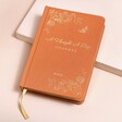 Personalised Orange Five Year Thought a Day Journal on top of beige coloured backdrop