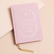 Pink Sun and Moon Fabric Notebook on top of beige coloured surface