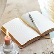 Pink Sun and Moon Fabric Notebook open with pen on open page
