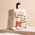 Traditional Mini Panettone in Hanging Gift Box on top of neutral surface with fake snow