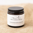 The Candle Brand Lemongrass and Geranium Scented Candle on natural coloured material