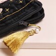 Close Up of Tassel on House Of Disaster Forage Black Makeup Bag