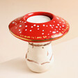 House of Disaster Forage Mushroom Tea Light Holder with candle on top of pink surface