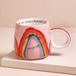House of Disaster Overwhelmed Rainbow Mug on Pink Surface
