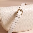 Close up of strap on Woven Vegan Leather Crossbody Bag in Beige