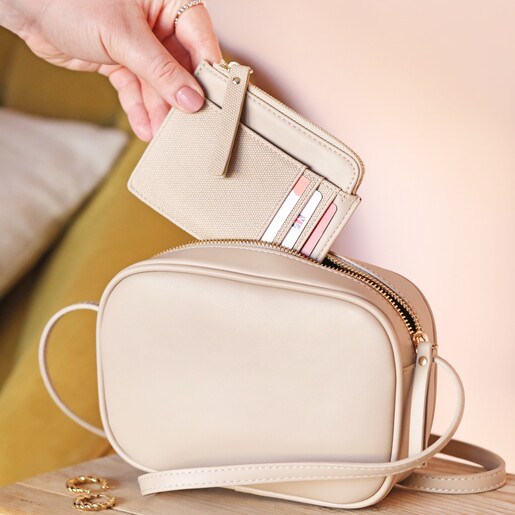 Model Putting Vegan Leather Card Holder in Beige into Bag
