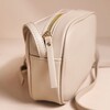 Side of Rectangular Crossbody Bag in Beige showing zip fastening