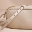 Close up of strap on Rectangular Crossbody Bag in Beige 