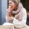 Model biting cake wearing Rectangular Crossbody Bag in Beige 